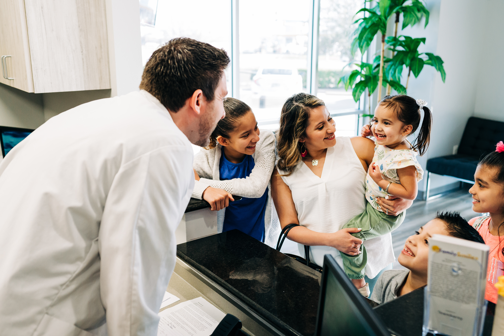 CDP dentist welcoming family into the dental office.