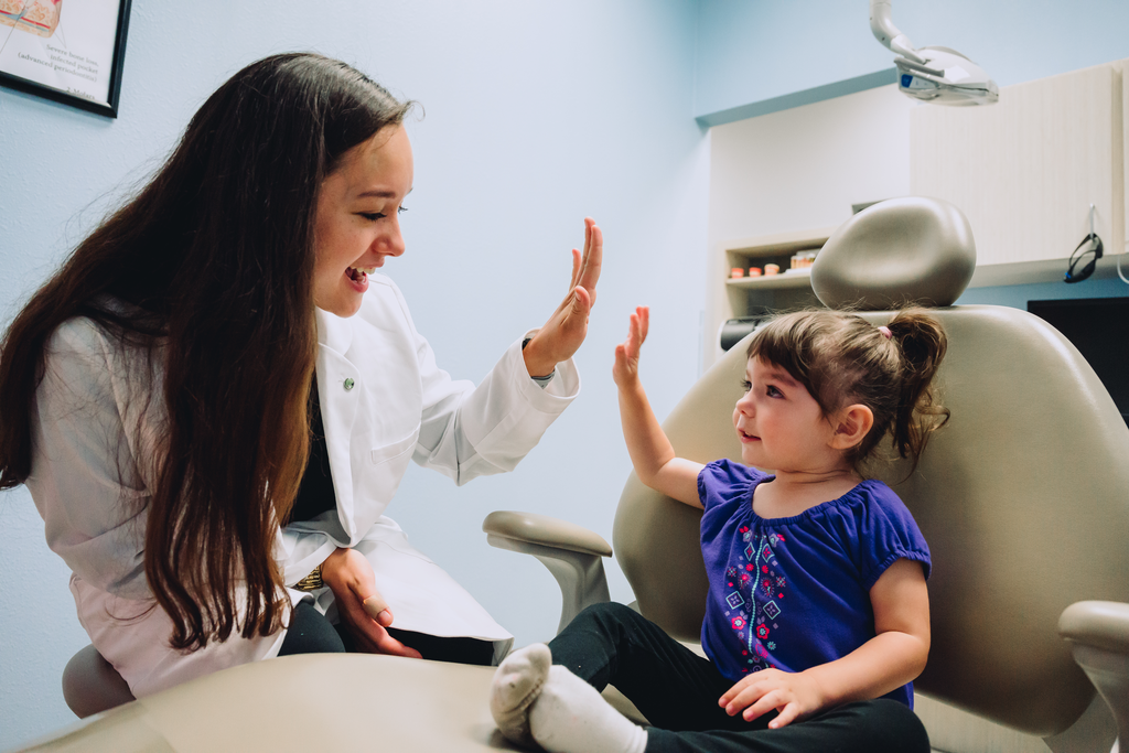 Happy dentist with happy child patient. Our DSO supports you!